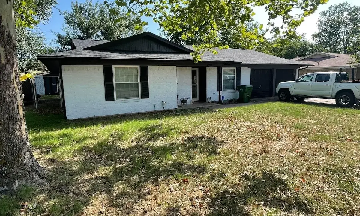 Professional roofing crew working on a residential roof in Tahlequah